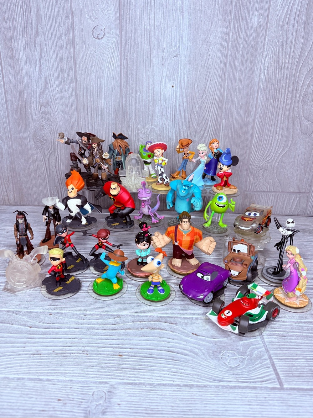 32 Disney infinity game pieces cars , princess , Toy Story , monsters inc & more